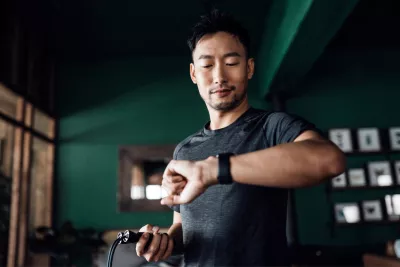 A man checks his heart rate on his smart watch.