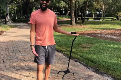 Brandon walking with his cane