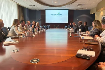 Pictured right leaning on the table: Abel Biri, AdventHealth Waterman CEO, emphasizes the hospital's dedication to quality care, community support and economic contributions in Lake County.