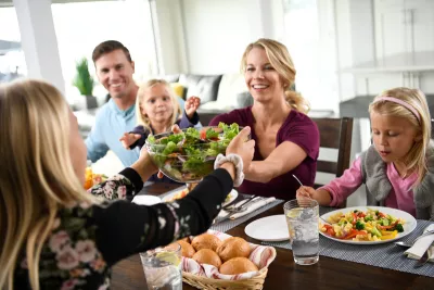 Family enjoys meal together at the dinner table