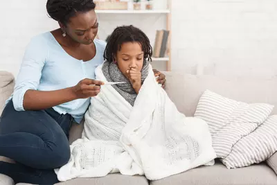 A mother taking her sick child's temperature 