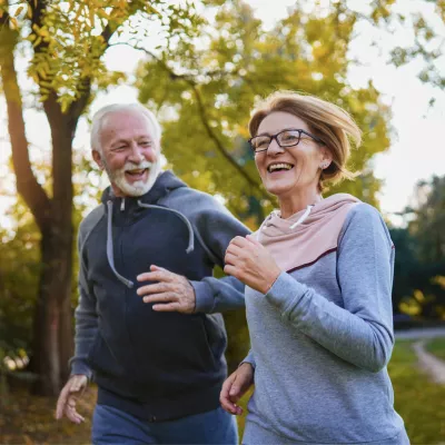 A Senior Couple Goes for a Run in a Park