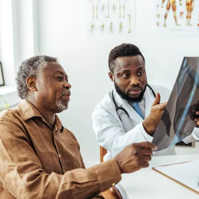 A Doctor Goes Over an X-Ray with a Patient