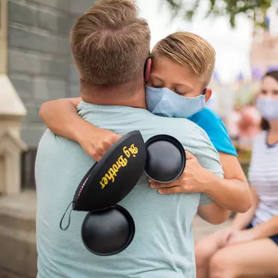 Son hugging dad after Dad telling him he is going to be a big brother.