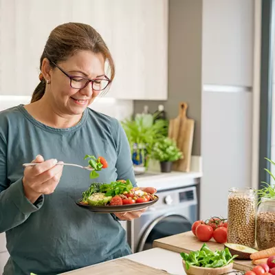 A woman eating a health plant-based meal.