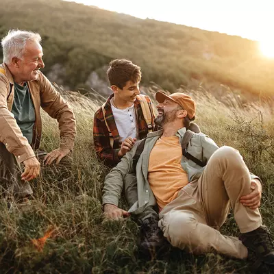A grandfather, father, and son hiking