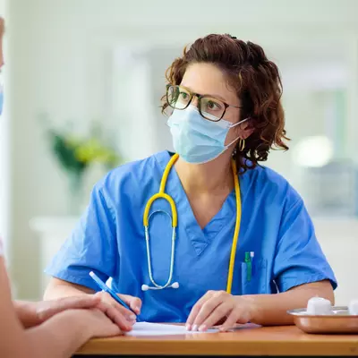 A woman visiting her health care provider. 