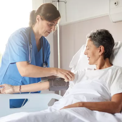 nurse and patient in hospital room