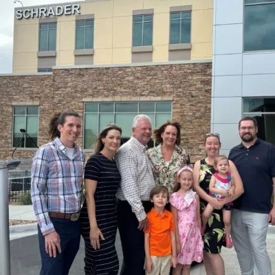 Schrader Family standing in front of the Schrader Building at AdventHealth Castle Rock