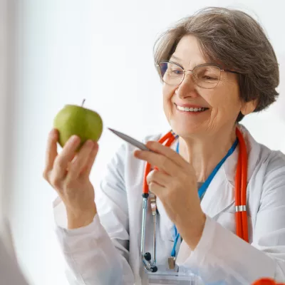 A Physician Points to an Apple with a Pen