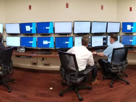 Doctors viewing 24 monitors inside of the Epilepsy Monitoring Unit at AdventHealth Tampa