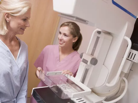 Mammogram technician with patient