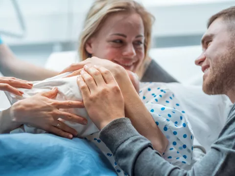 A happy family celebrates their new baby.