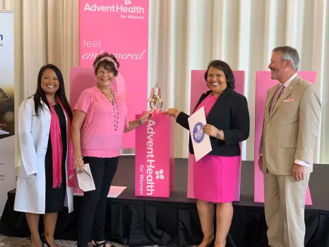 Breast cancer survivors ringing the Pink Out bell. 