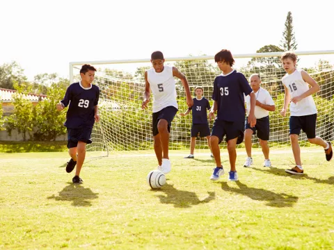 Children playing soccer safely.