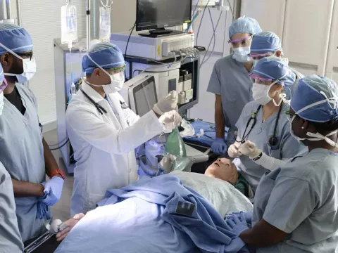 A group of surgical trainees conducting a mock surgery