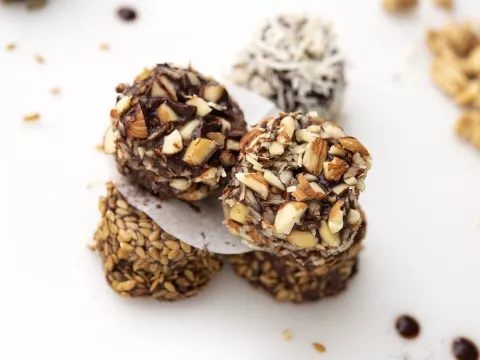 Five stacked bon bons on white surface