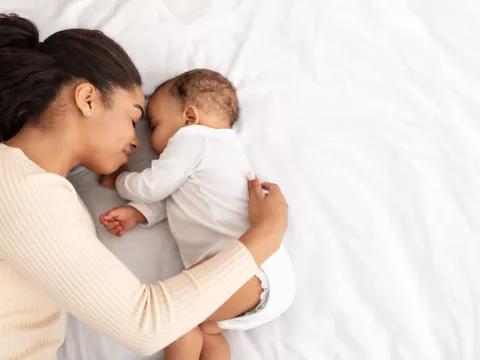 new mom cuddles with her newborn baby