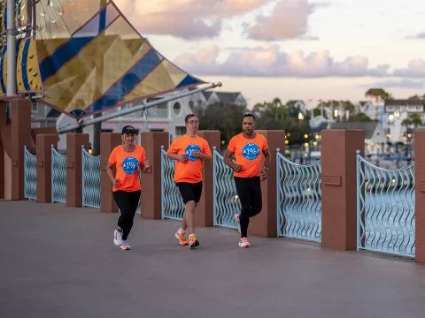 Chris Nikic Running with his team.