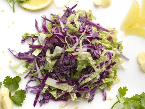 Mound of napa cabbage salad with cilantro garnish