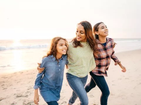 Mother and Daughters Walking on the Beach