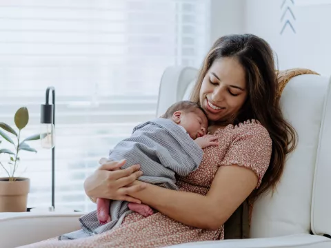 mother cuddles with new baby