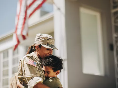 mother and veteran hugs son