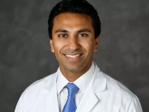 A professional headshot of Dr. Raj Martinez