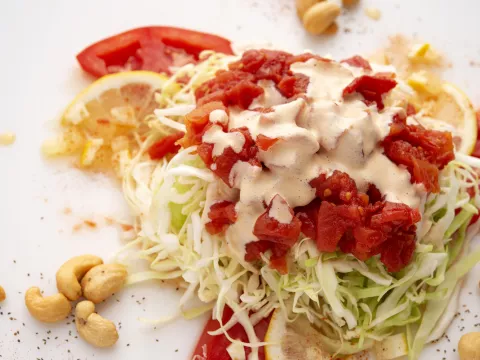 Mound of tomato slaw with lemon and tomato garnish