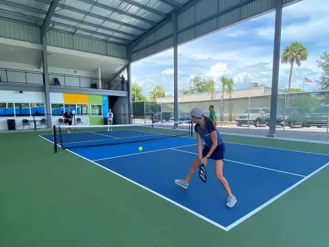 Two pairs of ladies playing pickle ball