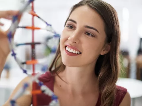 A woman studies DNA.