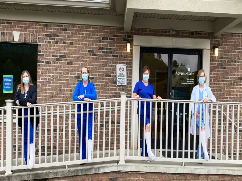 Four AdventhHealth women standing in front of their workplace