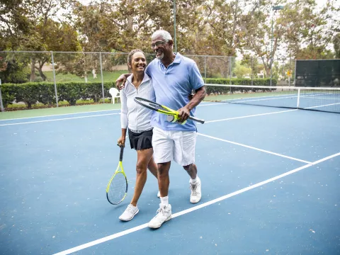 couple walks away from tennis court feeling great