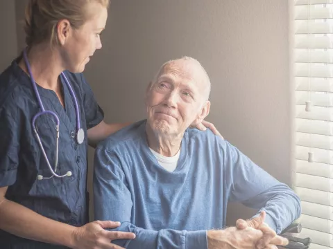 Nurse with a male hospice patient.