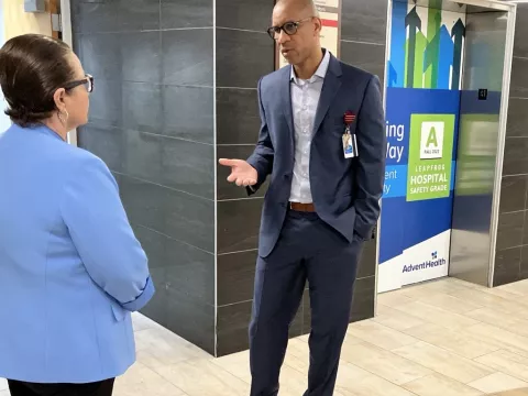 Lorenzo Brown talks with Deltona City Commissioner Avila-Vazquez in the lobby of AdventHealth Fish Memorial.