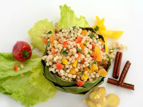 seasoned couscous pearls plated inside an artichoke