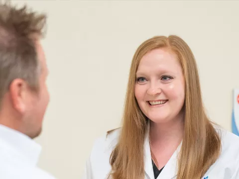 A nurse called, Tiffany Kelley, talking with a patient.