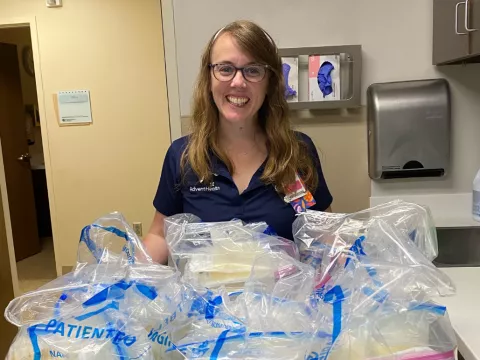 Laura Baran, a NICU nurse educator, with some of the breastmilk she donated.