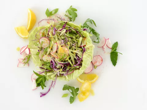 Mound of cabbage slaw with orange slice garnishes