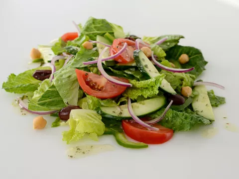 Mound of Greek salad on white surface