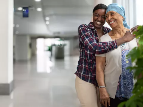 Cancer mom and daughter hugging