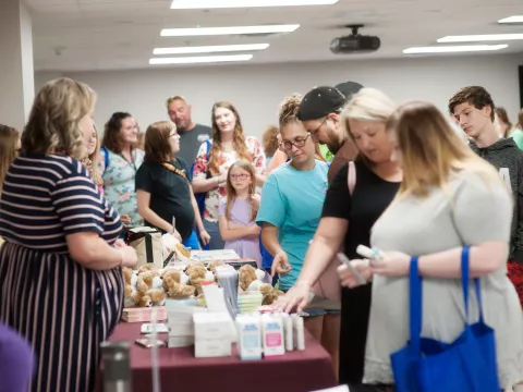 People waiting for a table booth at the Maternity Fair