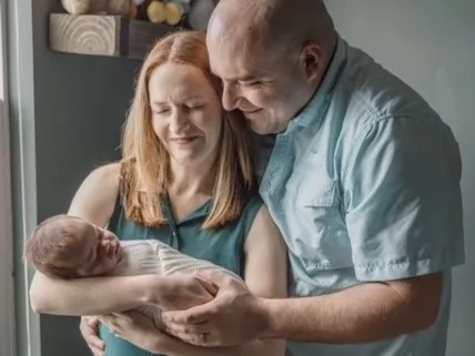 Kate F and her Husband with their baby