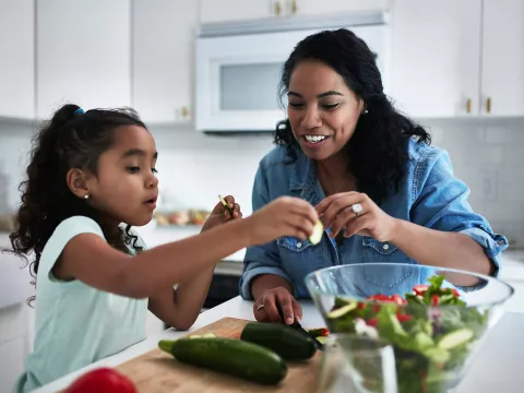 A Mother and Her Daughter Make a Healthy Salad In the Kitchen