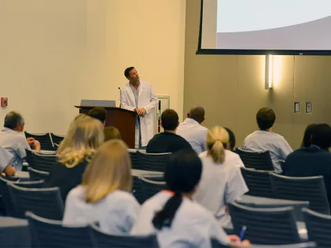 Man speaking at a conference.