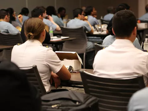 Professionals attending a conference in a Nicholson Center Eduction Center room.