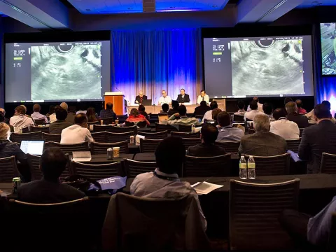 Professionals attending a conference in a Nicholson Center Eduction Center room.