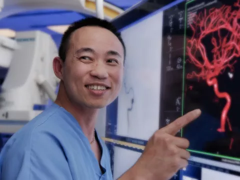 A nurse pointing his finger on the medical screen