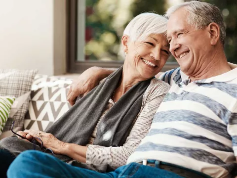 A mature couple relaxing on the their couch