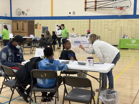 People receiving medical care by a volunteer at a Chicago Mission Clinic location.